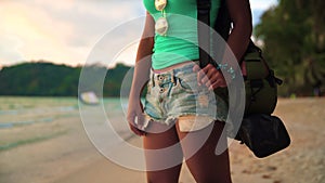 Carefree girl with tanned skin enjoying sunset over tropical beach on nature background