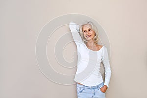 Carefree happy older woman with hand to head