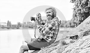 Carefree and happy. photographer use vintage camera. bearded man hipster take photo. photo shooting outdoor. brutal man