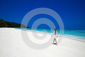 Carefree happy woman walking on tropical beach, exotic island. S