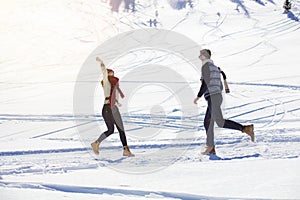 Carefree happy young couple having fun together in snow.