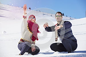 Carefree happy young couple having fun together in snow.