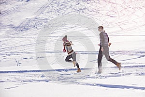 Carefree happy young couple having fun together in snow.