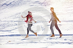 Carefree happy young couple having fun together in snow.