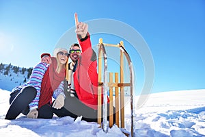 Carefree happy young couple having fun together in snow.