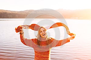 Carefree happy young girl jumping with scarf