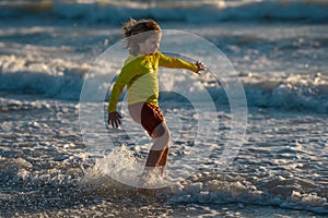Carefree kid running on sea. Happy cute child running near ocean on warm summer day. A Cute little kid boy running and