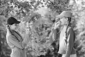 carefree kids posing outdoor for photo. Positive models. Casual hipsters outfit. portrait of happy sisters with