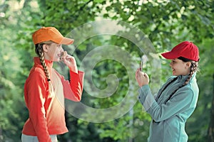 carefree kids posing outdoor for photo. Positive models. Casual hipsters outfit. portrait of happy sisters with