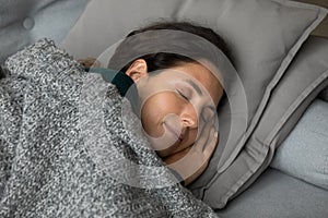 Carefree latina female sleep on couch put hands under cheek