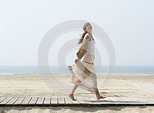 Carefree middle aged woman walking barefoot