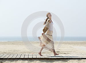 Carefree middle aged woman walking barefoot photo