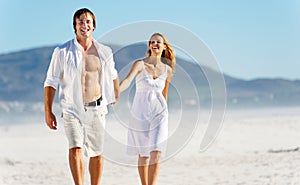 Carefree walking beach couple