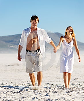 Carefree walking beach couple