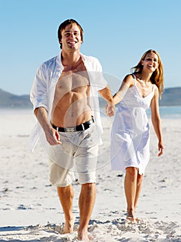 Carefree walking beach couple