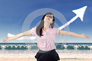 Carefree woman celebrating her success at beach