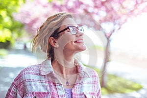 Carefree woman enjoying walking during springtime in park