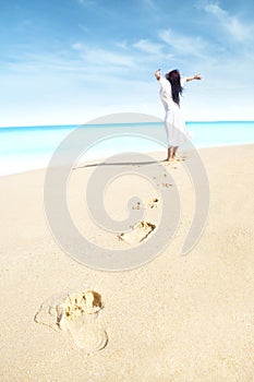 Carefree woman with footprint photo