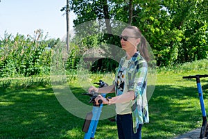 Carefree woman go for drive on rental electric scooter in park.