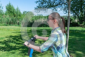 Carefree woman go for drive on rental electric scooter in park.