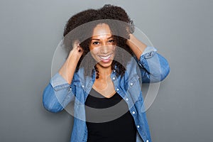 Carefree woman smiling with hand in hair photo