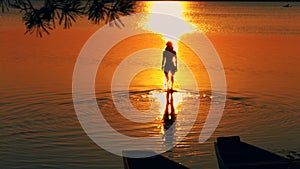 Carefree woman in the sunset on the beach. vacation vitality healthy living concept