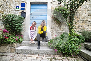 Carefree women sit outside and chat casually