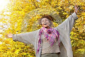 Carefree young african american woman with arms outstretched