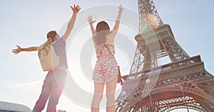 Carefree young couple celebrating in front of the Eiffel Tower. Carefree young couple celebrating in front of the Eiffel