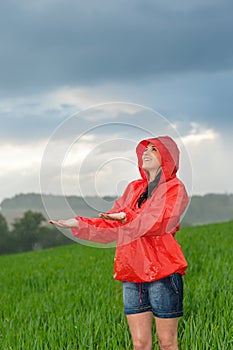 Carefree young girl enjoying rainy weather