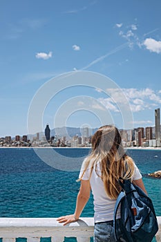 Carefree young tourist woman in sun hat enjoying sea view at Balcon