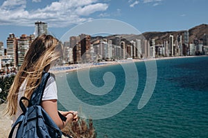 Carefree young tourist woman in sun hat enjoying sea view at Balcon