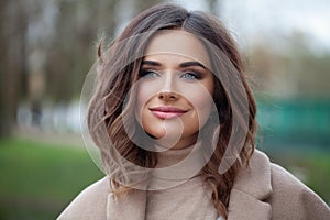 Carefree young woman brunette smiling, outdoor portrait