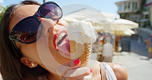 A carefree young woman enjoying ice cream while on holiday