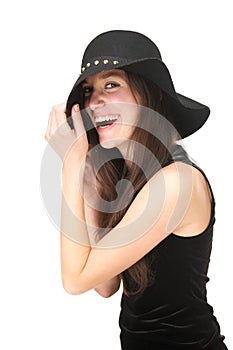 Carefree young woman laughing with black hat