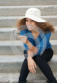 Carefree young woman laughing outdoors