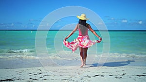 Carefree young woman relaxing on exotic beach. Caribbean tropical vacation