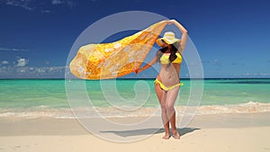 Carefree young woman relaxing on exotic beach. Caribbean tropical vacation. Dominican Republic.