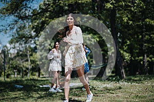 Carefree young women enjoying a sunny day in the park, dressed in casual summer outfits