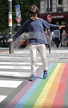 Careful girl balancing arms, crossing the fun street with serenity