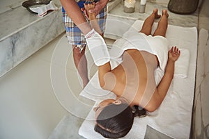 Careful man wearing kese while making pleasant procedure in hammam