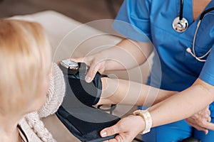 Careful patient doctor providing medical service at home