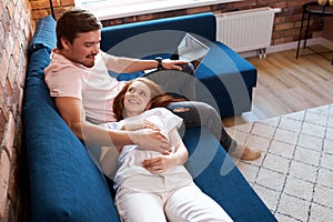 Careful responsive man stroke pregnant belly of wife