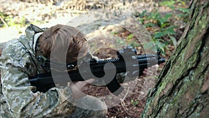 Carefully aiming, forest battle, camouflage shooter