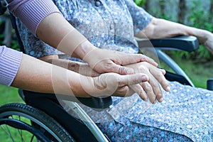Caregiber holding hands Asian senior or elderly old lady woman patient with love, care, encourage and empathy at nursing hospital
