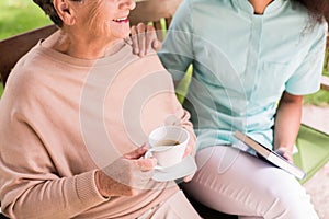 Caregiver caring about female pensioner