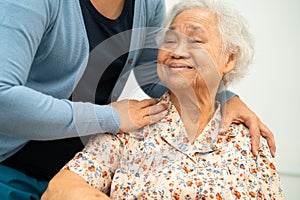 Caregiver help Asian elderly woman patient with love, care, encourage and empathy at nursing hospital, healthy strong medical photo