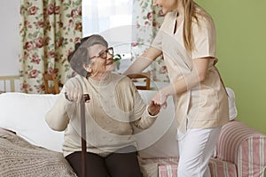 Caregiver helping senior woman