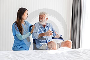 Caregiver nurse take care a Senior patient sit on wheelchair. Nurse helping senior Man