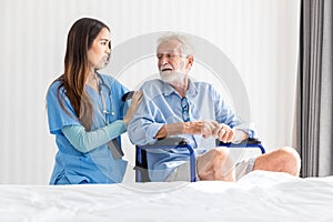 Caregiver nurse take care a Senior patient sit on wheelchair. Nurse helping senior Man